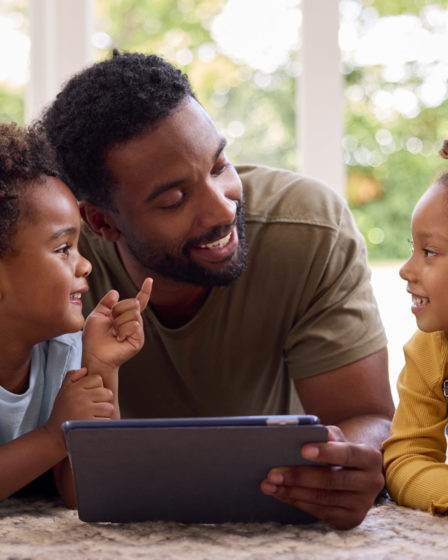 Father and children at home with tablet, family lifestyle and home repairs.