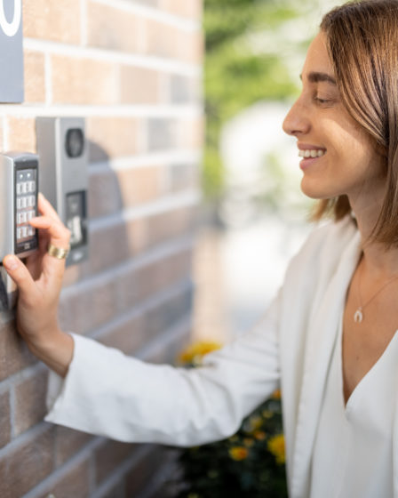 Woman entering code on a keyboard to access a door